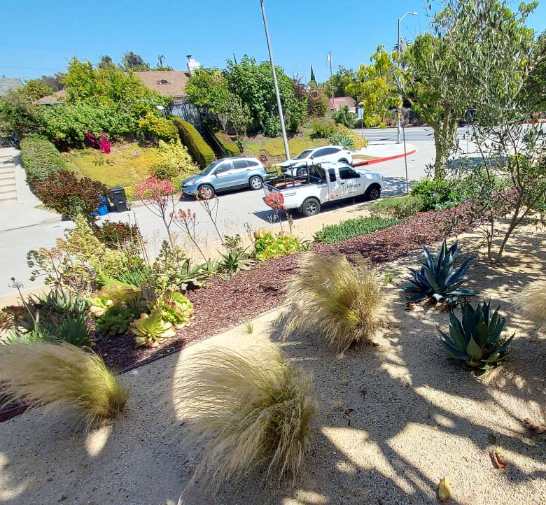 nitrogen landscapes' truck in house front and the landscape completed