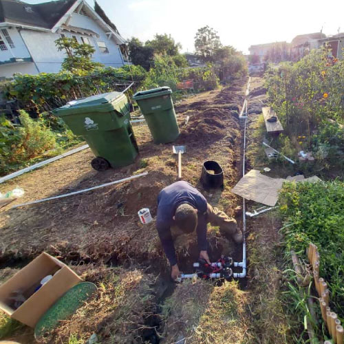 landscaper installing irrigation system