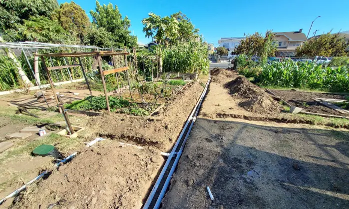 Trench excavation for PVC irrigation pipeline and commercial drainage system installation in Los Angeles.